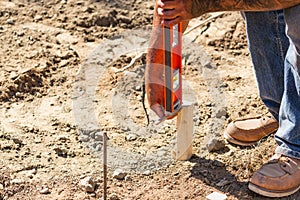 Worker Using Level At Construction Site