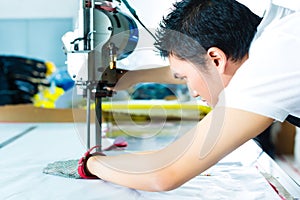 Worker using a machine in chinese factory