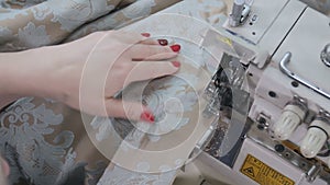 Worker using machine for cutting fabrics