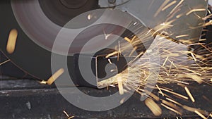 Worker using metal cutting circular saw blade in construction site