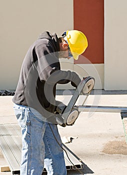 Worker Using Porta-Band Saw