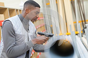 Worker using scanner in warehouse