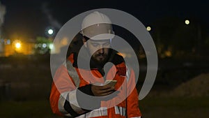 Worker using smartphone in the twilight. Night shift concept 4k