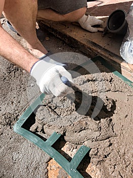 Worker hands using spatula, plastic form and plastering ceiling with putty. Mesh on split. Closeup