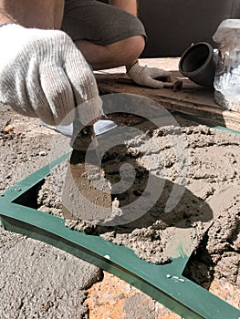 Worker hands using spatula, plastic form and plastering ceiling with putty. Mesh on split. Closeup