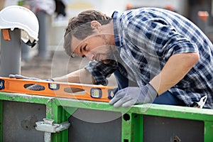 worker using spirit level on wall