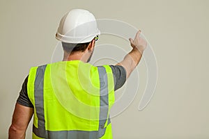 Worker in a vest and white helmet