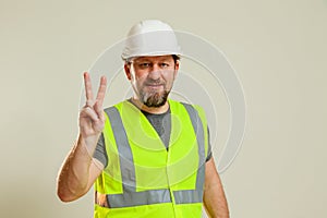 worker in a vest and white helmet