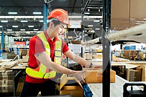 Worker In Warehouse Preparing Goods For Dispatch