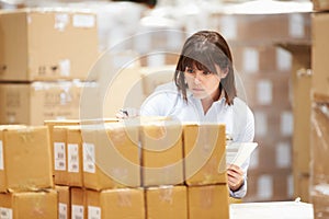 Worker In Warehouse Preparing Goods For Dispatch