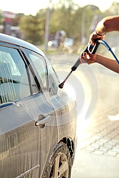 Worker wash the car with high pressure washer