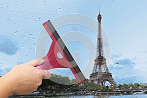 Worker washes the window after the rain
