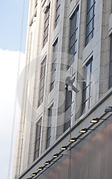 A worker is washing the building located in shanghai