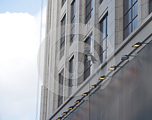 A worker is washing the building located in shanghai