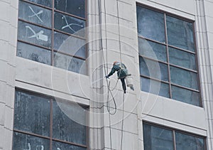 A worker is washing the building located in shanghai