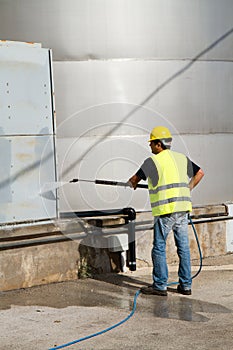 Worker washing industrial site