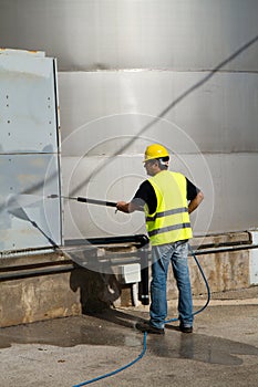 Worker washing industrial site