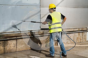 Worker washing industrial site