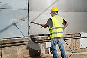 Worker washing industrial site