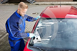 Worker Washing Windshield