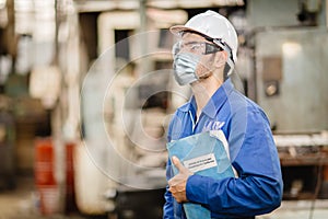 Worker wearing face shield or disposable face mask with CoronavirusCovid-19 Prevention guidlines manual hand book for guidance