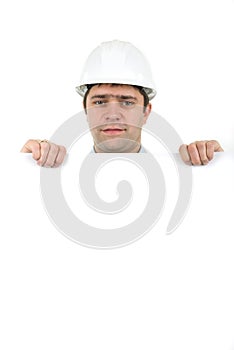 Worker wearing hard hat and holding empty banner