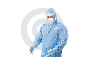 Worker wearing a hasmat coverall, maskgloves  and face shield