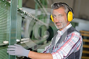Worker wearing hearing protection at factory