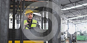 worker wearing helmet with driver forklift in warehouse