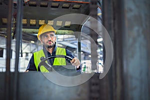 worker wearing helmet with driver forklift in warehouse