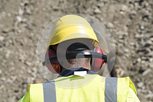 Worker wearing helmet and hearing protection