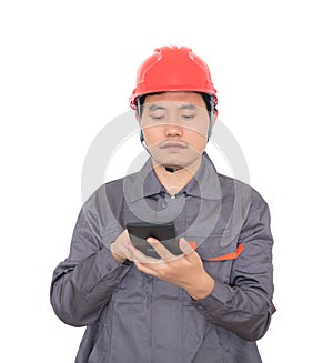 Worker wearing red hard hat is using calculator to calculate