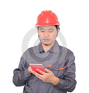 Worker wearing red hard hat is using calculator to calculate