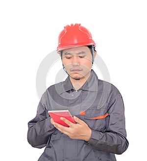 Worker wearing red hard hat is using calculator to calculate