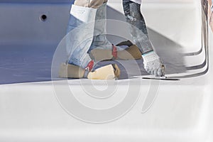 Worker Wearing Sponges On Shoes Smoothing Wet Pool Plaster With Trowel