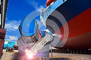 Worker Welding close-up at floating dry dock in shipyard for ship repair