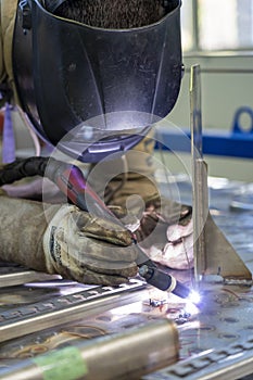 Worker With Welding Helmet And Protective Workwear Welding Train Construction