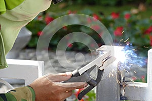 The worker welding the iron pole