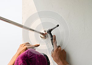 Worker welding stainless steel pipe clothesline