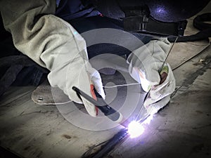 Worker welding stainless tank using tig welder