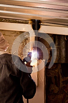 Worker welding steel