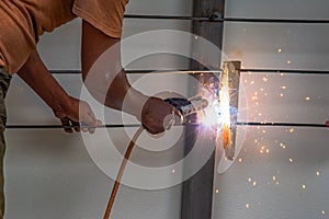Worker welding steel bar.