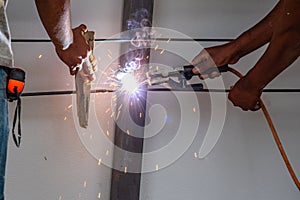 Worker welding steel bar.