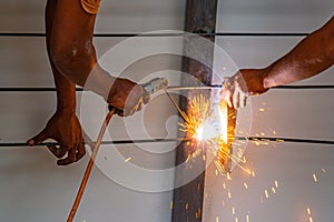 Worker welding steel bar.