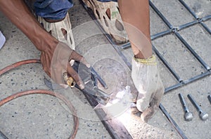 Worker welding steel bars.