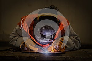 Worker welding the steel part