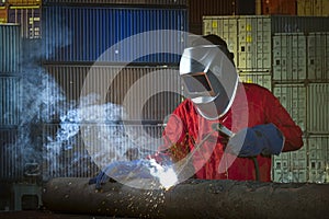Worker welding the steel pipe structure