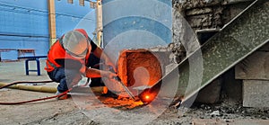 A worker welding steel using the oxygen cutting method uses gases that emit flames.