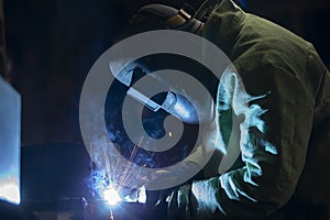 A worker in a welding suit