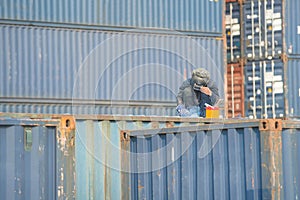 Worker welding to repair container box in port